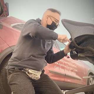 A skilled worker from Number2project repairing furniture, indicating a valuable business opportunity in the furniture repair industry.