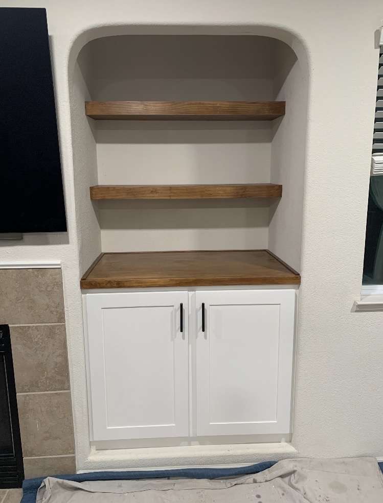 A newly installed custom built-in cabinet and floating shelves designed by Number2Project, exemplifying their custom furniture services.