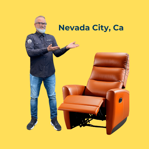 Man with glasses and a gray beard demonstrating a leather recliner chair, with 'Nevada City, Ca' inscribed on a yellow background.