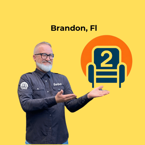 Sebo from Number2project Mobile Furniture Repair pointing to the company logo, promoting sofa and recliner repair services in Brandon, FL.