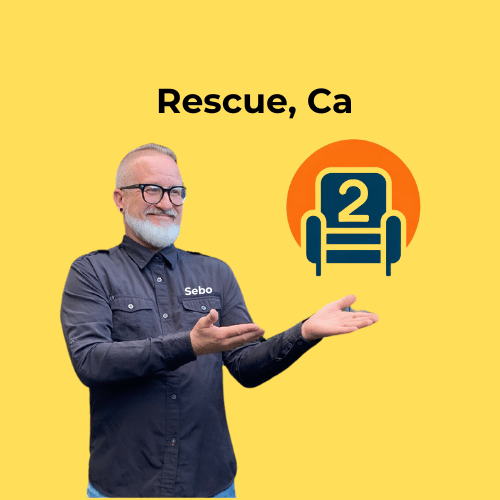 Sebastian in a Number2project shirt, smiling and pointing toward the recliner logo with "Rescue, CA" above on a yellow background.