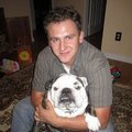 Customer with bulldog, symbolizing satisfaction and trust in Jim’s Auto Tops & Upholstery — the best car upholstery shop in Folsom, CA.