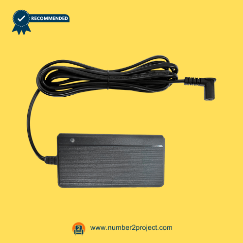 Black recliner power adapter with a long, coiled cable and right-angle connector on a yellow background.