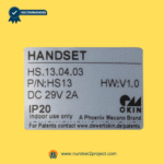 OKIN HS.13.04.03 handset controller identification label showing model HS.13.04.03, part number HS13, 29V DC 2A power rating, IP20 indoor use specification for power recliner and electric lift chair remote, genuine OKIN DewertOkin Phoenix Mecano technology branding – Sold by Number2project Sofa & Recliner Repair Experts