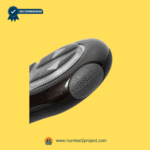 Close-up side view of a recliner remote showing a textured ergonomic grip on a yellow background.